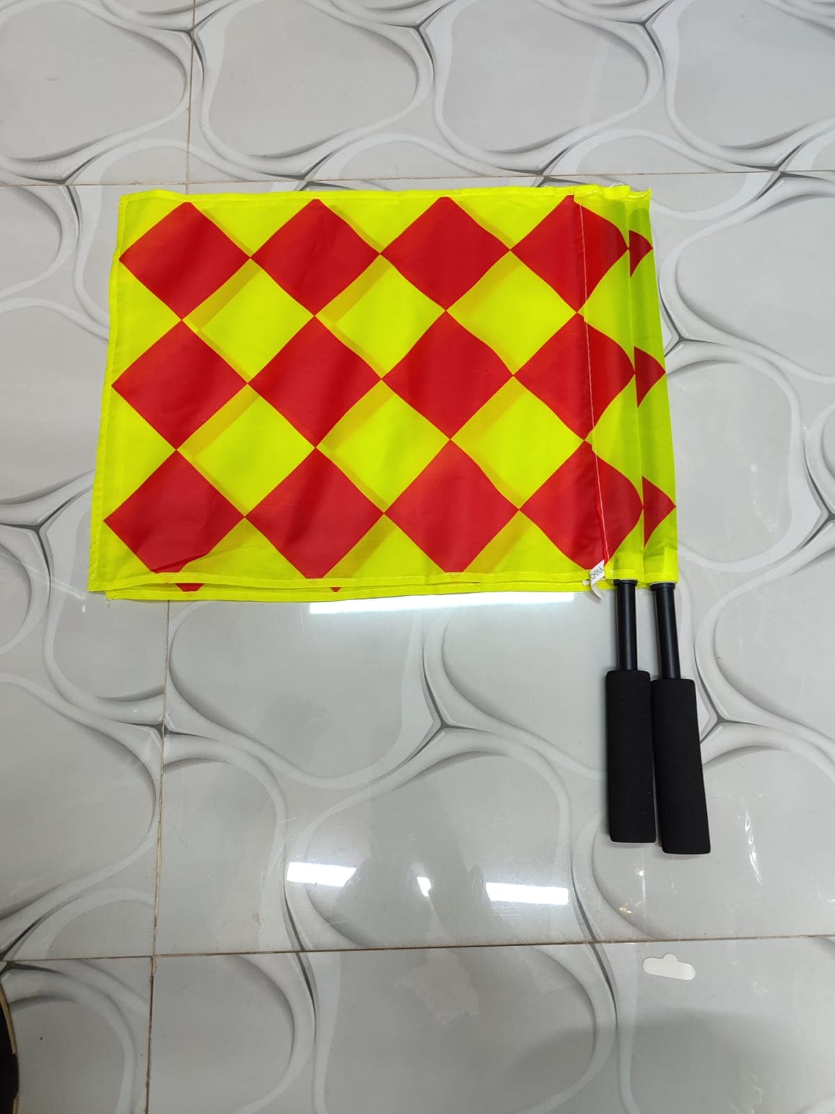 A pair of assistant referee flags designed for football match officials. The flags feature a highly visible fluorescent yellow and red checkered pattern, making them easy to see from a distance. gallery 2